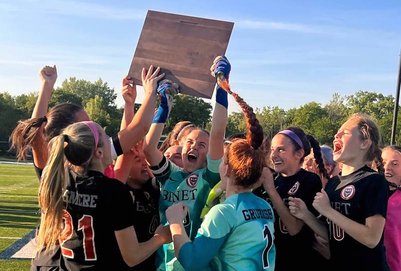 Members of the Benet girls soccer team celebrate with their plaque after defeating Lemont 4-0 in the Class 4A Nazareth Sectional championship Friday, May 26, 2023 in LaGrange Park.