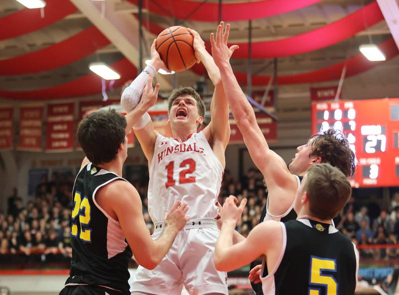 Hinsdale Central's Ben Oosterbaan (12) puts up a shot in traffic during the boys 4A varsity sectional semi-final game between Hinsdale Central and Lyons Township high schools in Hinsdale on Wednesday, March 1, 2023.