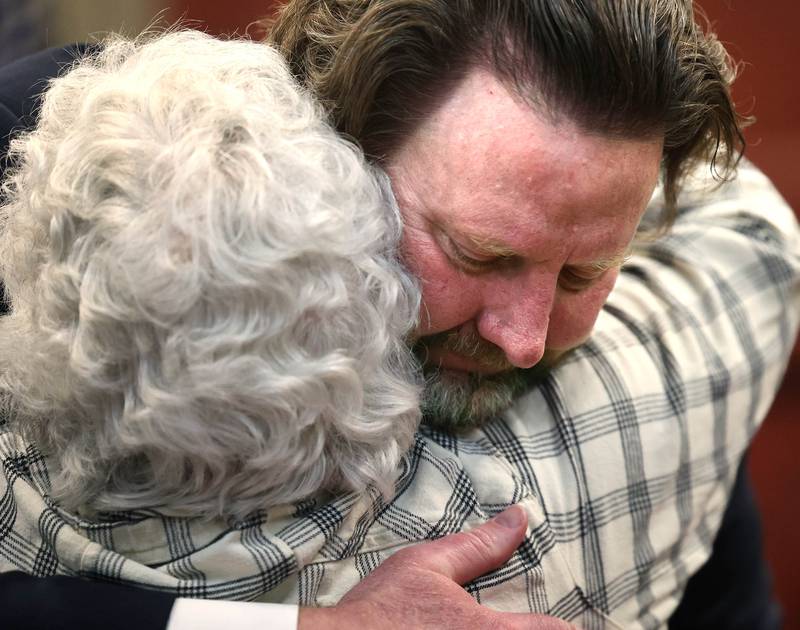 Sue Saari daughter of Patricia Wilson and sister of Robert Wilson gets a hug from lead prosecutor Scott Schwertley Thursday, Jan. 30, 2025, at the DeKalb County Courthouse, after Jonathan D. Hurst was found guilty of the 2016 murders of Patricia and Robert.