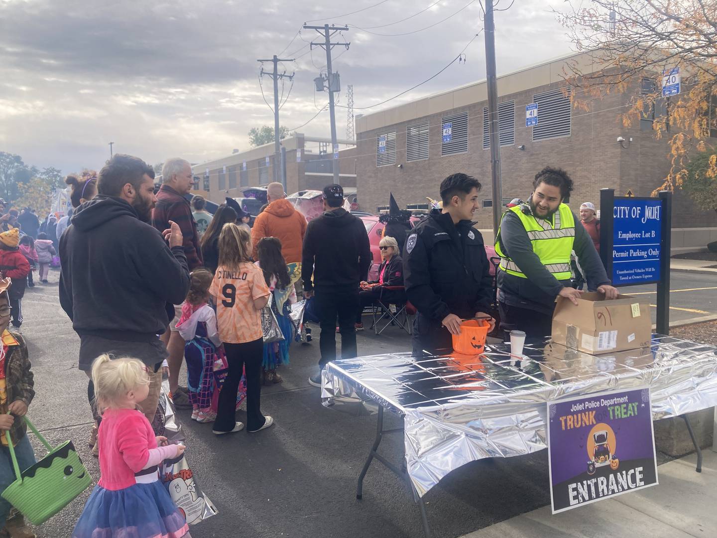 Joliet Police Department volunteers pass out bags and collect votes for best trunk at the JPD's trunk-or-treat event. 
Saturday, Oct. 25, 2025.