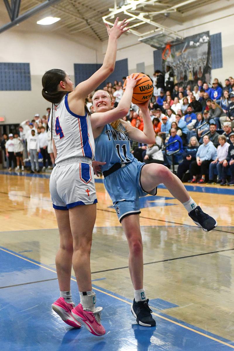 Cissna Park's Sophia Duis goes for a layup against St. Teresa's Jalie Eller during the Timberwolves' 47-35 victory over St. Teresa in the IHSA Class 1A Blue Ridge Super-Sectional on Monday, March 3.
