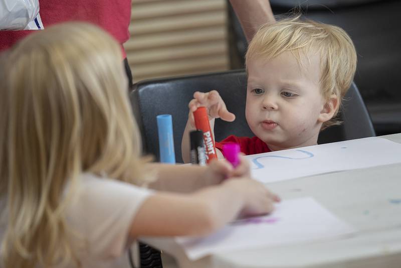 Shawn Tedder, 2, of Morrison, checks out some colorful markers Wednesday, June 25, 2025, at a craft booth at the Odell Library in Morrison. The crafts were part of Dolly Parton's Imagination Library.