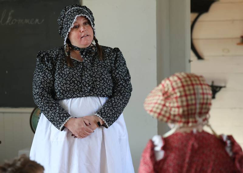 Southeast Elementary School third grade teacher Jami Sauber talks to student Brynlee Monney Tuesday, Nov. 4, 2025, during a field trip to North Grove School, a one-room schoolhouse from 1878 in Sycamore.