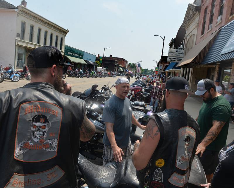 Pastor Jon Easlick (center) of Crossroads Church in Morrison, blesses motorcycles for riders belonging to a Sterling club during a "Blessing of the Bikes" in downtown Fulton on Sunday, June 4. Easlick was one of several clergymen who took part the event, organized by Fulton resident Jules Meiners, in conjunction with A.B.A.T.E of Iowa, District 21- an acronym for "A Brotherhood Aimed Towards Eduction".