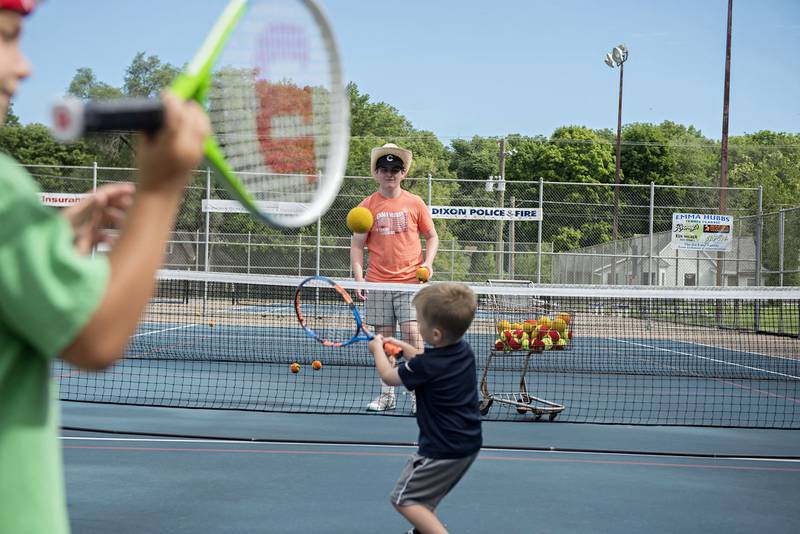 Instructor Jameson Ryan tosses the ball to Jack Reuter during the tiny tots event at the Emma Hubbs Tennis Classic Monday, July 25, 2022.