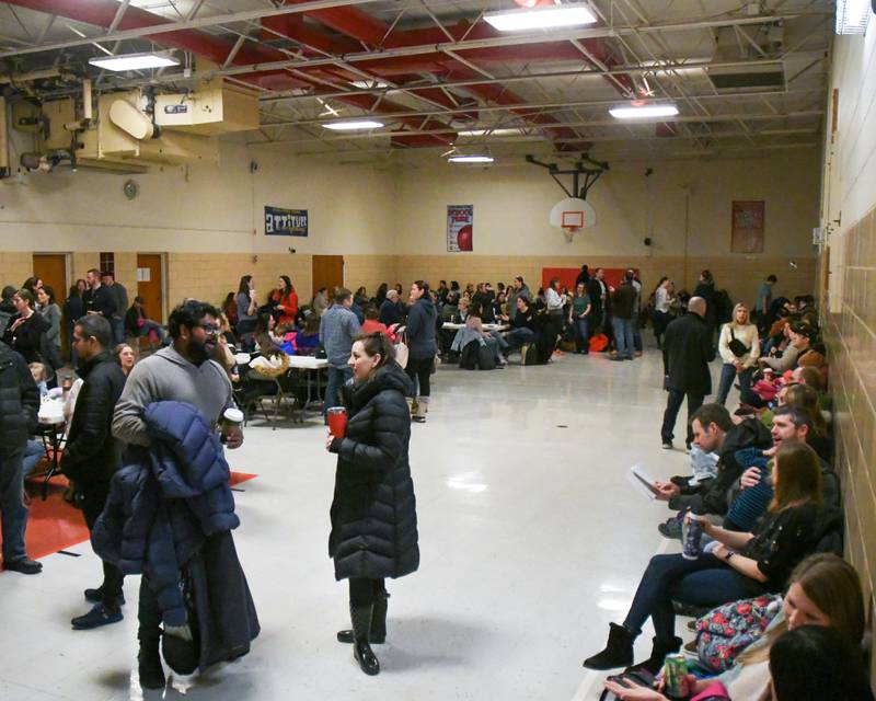 Family’s wait in another gym at O’Neill Middle School in Downers Grove during the District 58 science fair held on Saturday Jan. 20, 204.