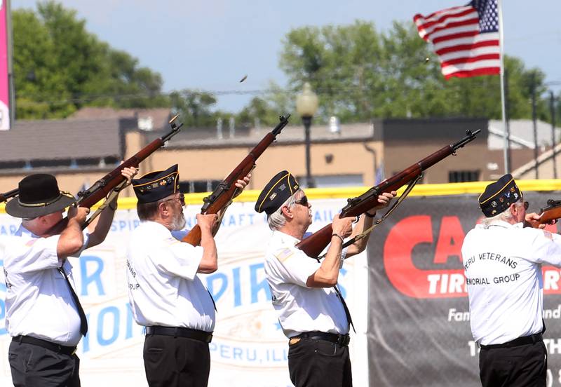 Members of the Peru Veterans Memorial Group conduct a 21 gun salute before the Illinois Valley Pistol Shrimp game honoring Veterans on Thursday, July 3, 2025 at Schweickert Stadium in Peru.