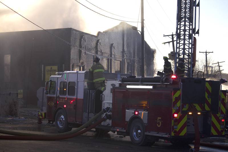 Joliet firefighters at the scene of a fire at an old commercial building on Thursday, Jan. 29, 2026, at the corner of South Eastern Avenue and Washington Street in Joliet.