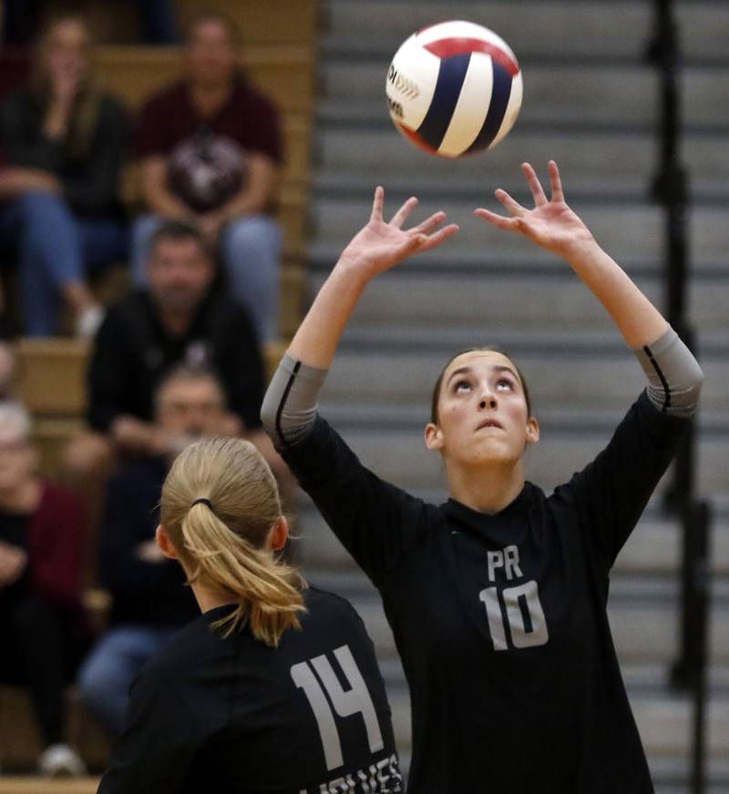 Prairie Ridge's Addison Smith sets the ball during a Fox Valley Conference volleyball match against Huntley on Tuesday, Oct. 8, 2024, at Huntley High School.