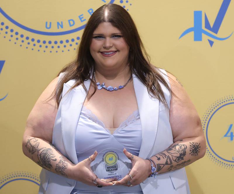 Nicole Salazar poses with her 40 Under Forty award during the Illinois Valley Chamber of Commerce Champions of Change Awards Night on Wednesday, May 6, 2026 at the Westclox Event Center in Peru.