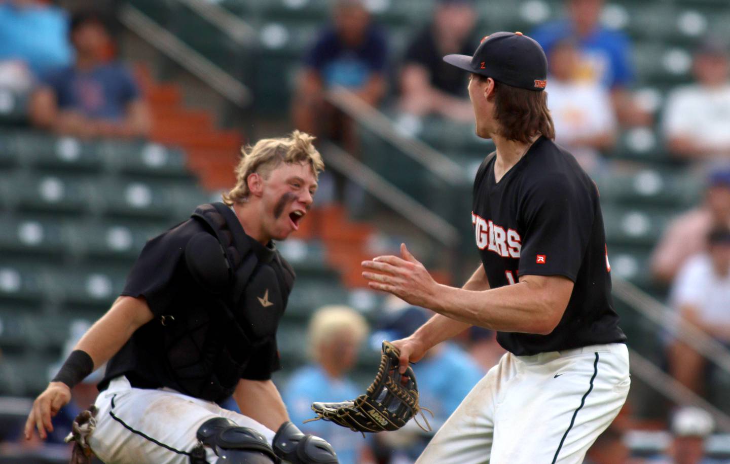 Crystal Lake Central’s Tigers begin to celebrate after the final out in supersectional baseball action against DePaul College Prep at Wintrust Field in Schaumburg Monday.