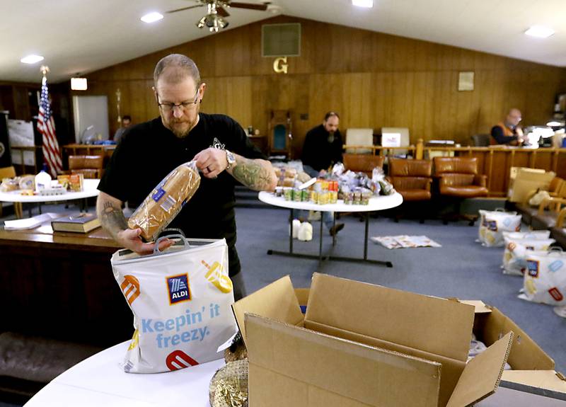 Rob Zerkel and other members of the Wauconda Masonic Lodge #298 package bags of groceries on Monday, Dec. 18, 2023, for about 45 McHenry County families, so they will have food for Christmas.