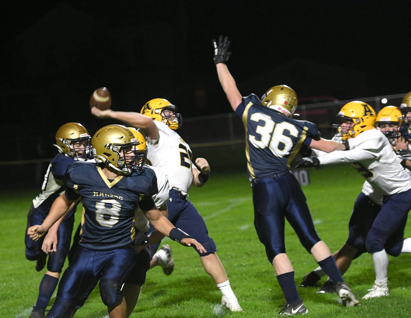 Polo's Wayde Reimer gets a hand in the air as other Marcos surround the Aquin quarterback.