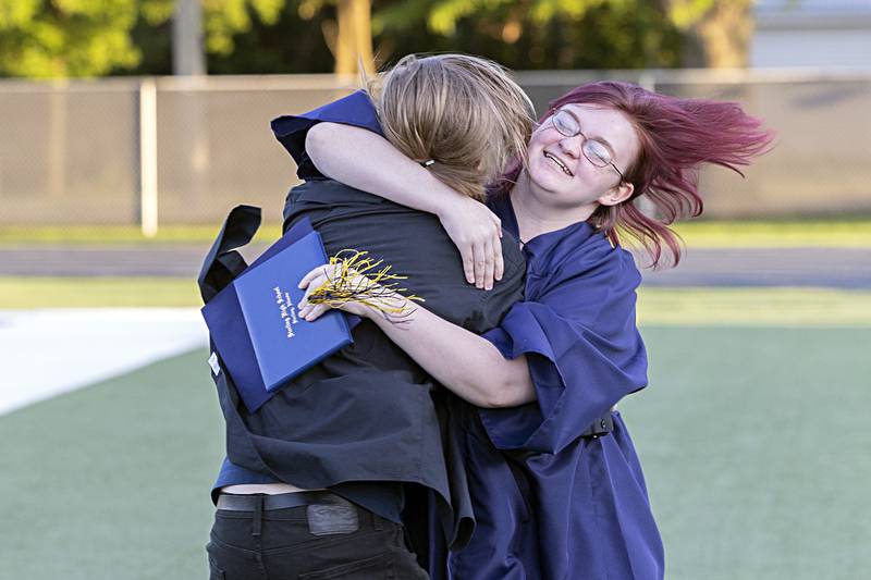 A newly graduated senior from Sterling High School hugs a loved one following the commencement ceremony Friday, May 26, 2023.