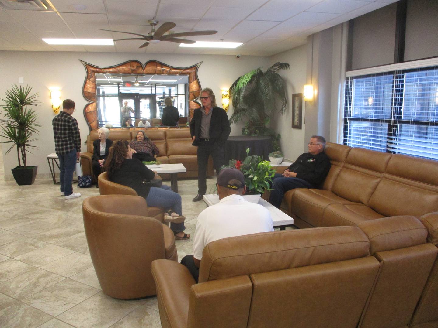 People wait in the lobby at Bays Tower for a ribbon-cutting ceremony on Thursday celebrating the opening of the apartment building in downtown Joliet. Oct. 16, 2025
