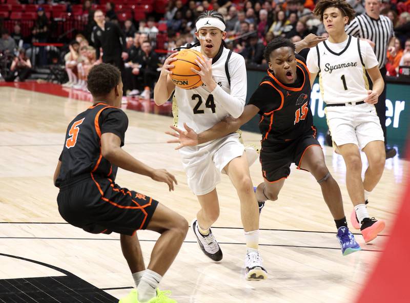 Sycamore's Unique Shaw drives between two DeKalb defenders during their game Friday, Jan. 31, 2025, in the FNBO Challenge in the Convocation Center at Northern Illinois University in DeKalb.