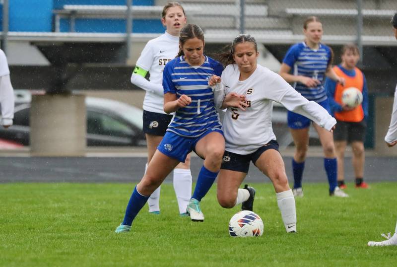 Princeton's Olivia Sandoval battles Sterling's Tatiana Ibarra (5) for the ball Thursday at Bryant Field. The Tigresses overcame the Golden Warriors and rain for a 3-1 victory.