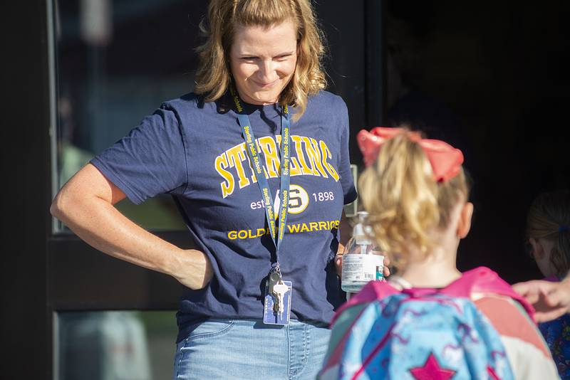 Cami Hartman, Sterling Jefferson School counselor, greets students at the front door of the building Wednesday, Aug. 17, 2022 for the first day of school.