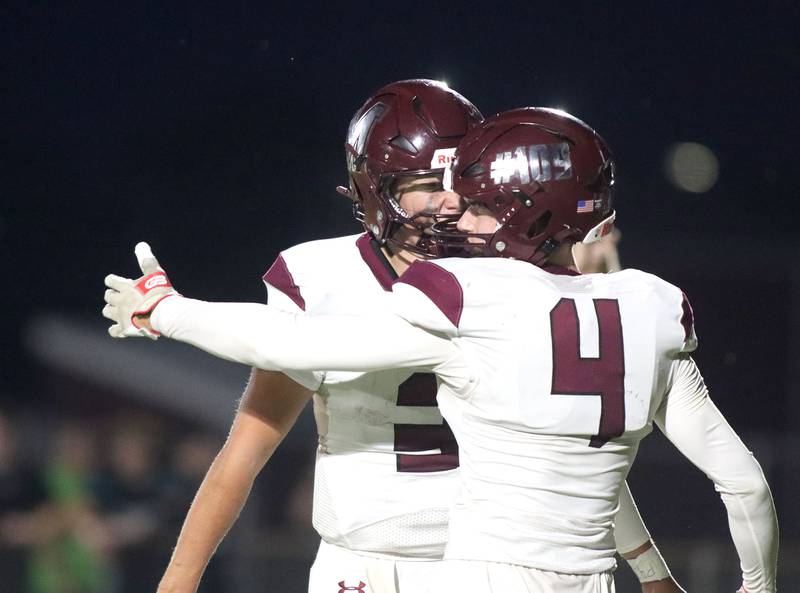 Marengo’s Sam Vandello, back, and Parker Mandelky (4) celebrate a touchdown against Woodstock North in varsity football at Rod Poppe Field on the campus of Marengo High School in Marengo on Friday, Sept. 12, 2025.