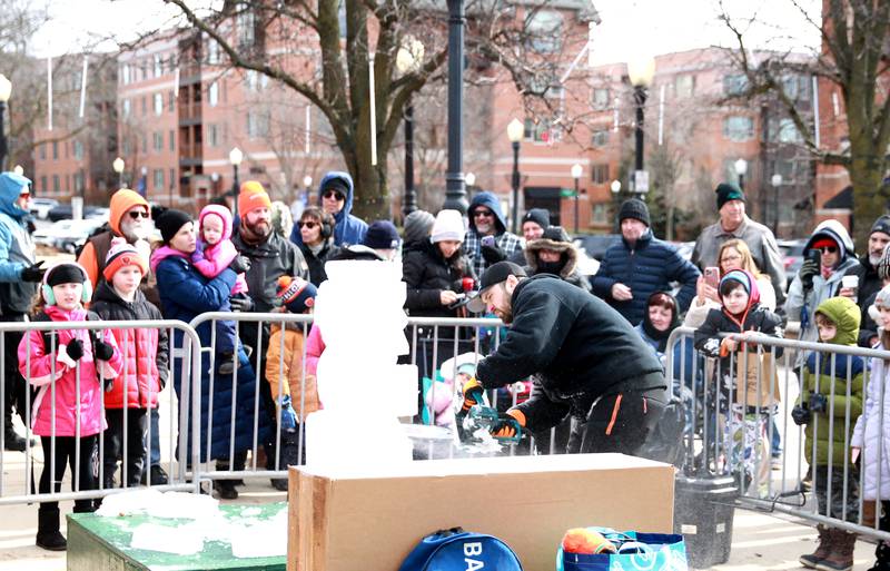 Jack Neiweem of Nadeau’s Ice Sculptures carves a sea horse out of a block of ice during the Downtown Downers Grove Ice Festival on Saturday, Feb. 1, 2025 in Downers Grove.