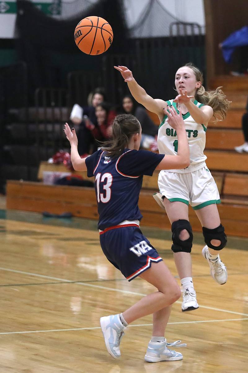 Alden-Hebron's Olivia Klein passes the ball to a teammate as she is guarded by Woodlands Academy's MacKenzie Lockhart during a nononference girls basketball game on Thursday, Jan. 29, 2026, at Alden-Hebron High School in Hebron.