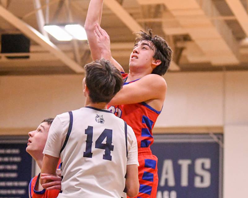 Glenbard South's Will Sieck (20) makes a basket while being defended by West Chicago's Joseph Trigueros (14) during the game on Friday Jan. 3, 2025, held at West Chicago High School.