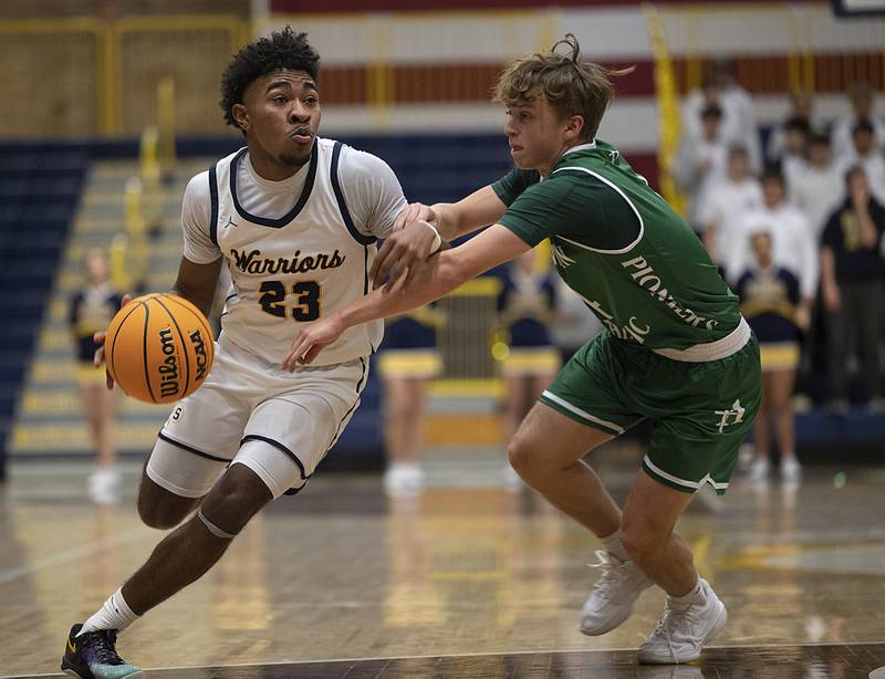 Sterling’s Kaedon Phillips drives past Alleman’s Adam Van Meighem Friday, Dec. 20, 2024, at at Sterling High School.
