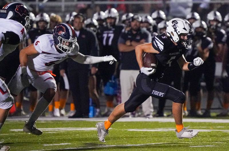 Plainfield North's Robert Tota (5) carries the ball for a touchdown against Oswego during a football game at Plainfield North High School on Friday, Sept. 22, 2023.