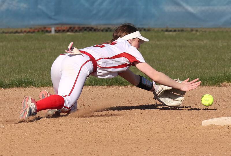 Oregon's Ella Dannhorn dives for a ball at shortstop during their game against the Cogs Tuesday, April 9, 2024, at Genoa-Kingston High School.