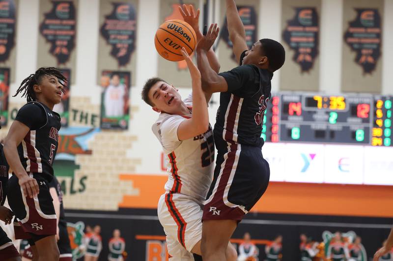 Plainfield East’s Danny Sepulveda collides with Plainfield North’s Eric Banas going to the basket on Tuesday, Jan 14, 2025.