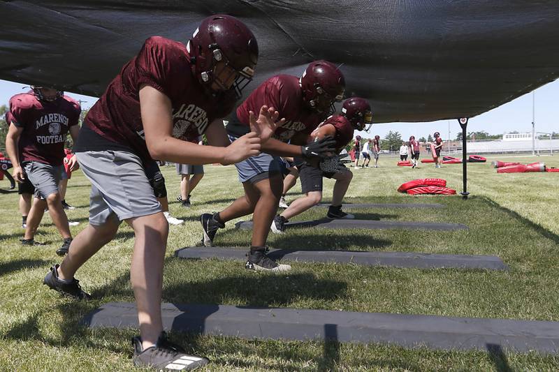 Linemen from the Marengo football program during a blocking drill during summer football practice Monday, June 27, 2022, at Marengo Community High School in Marengo.
