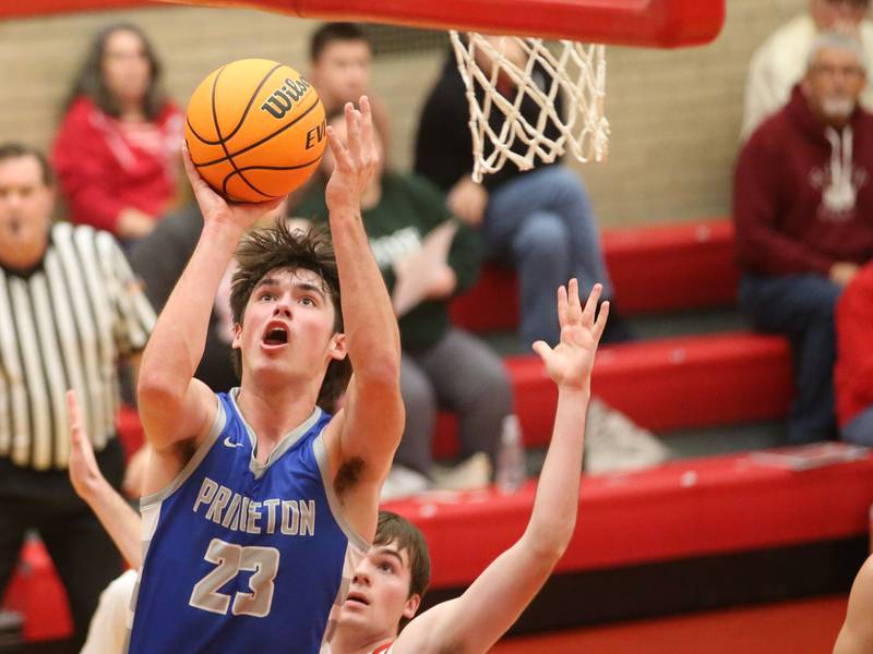 Princeton's Noah LaPorte lets go of a layup over Ottawa's Seth Cooper on Monday, Feb. 3, 2025 in Kingman Gymnasium at Ottawa High School.