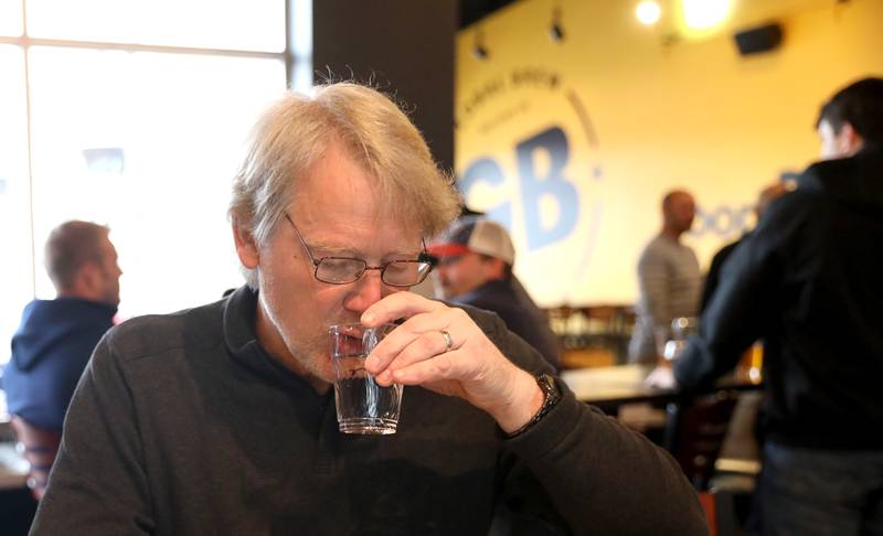 Paul Marschinke, retired from the City of St. Charles, tastes water from various villages and cities throughout Kane County during the annual Kane County Water Association Water Taste Test at Global Brew in St. Charles on Thursday, Dec. 15, 2022.