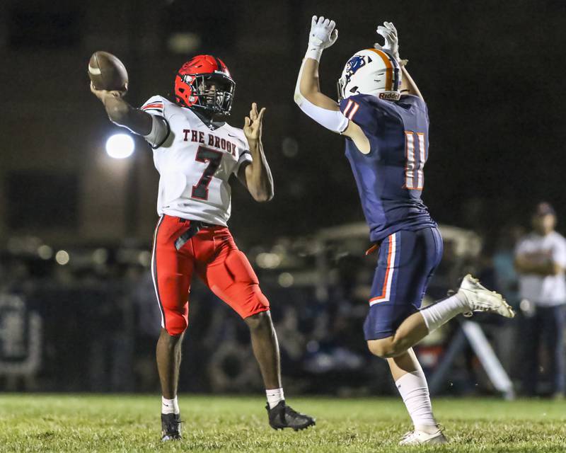 Bolingbrook's Tyson Ward (7) throws as he is pressured by Oswego's Caden Cooney (11) during football game between Bolingbrook at Oswego Friday, Sept 12, 2025  in Oswego.