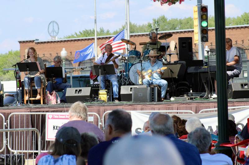 A crowd of more than a 100 congregates under shade trees and tents to listen to Lyle Grobe and the Rhythm Ramblers perform Sunday from the Stella main stage at the Dixon Petunia Festival. Grobe has appeared at all 58 Petunia Festivals, recorded the festival's anthem in 1968 and was the parade's grand marshal in 2009.