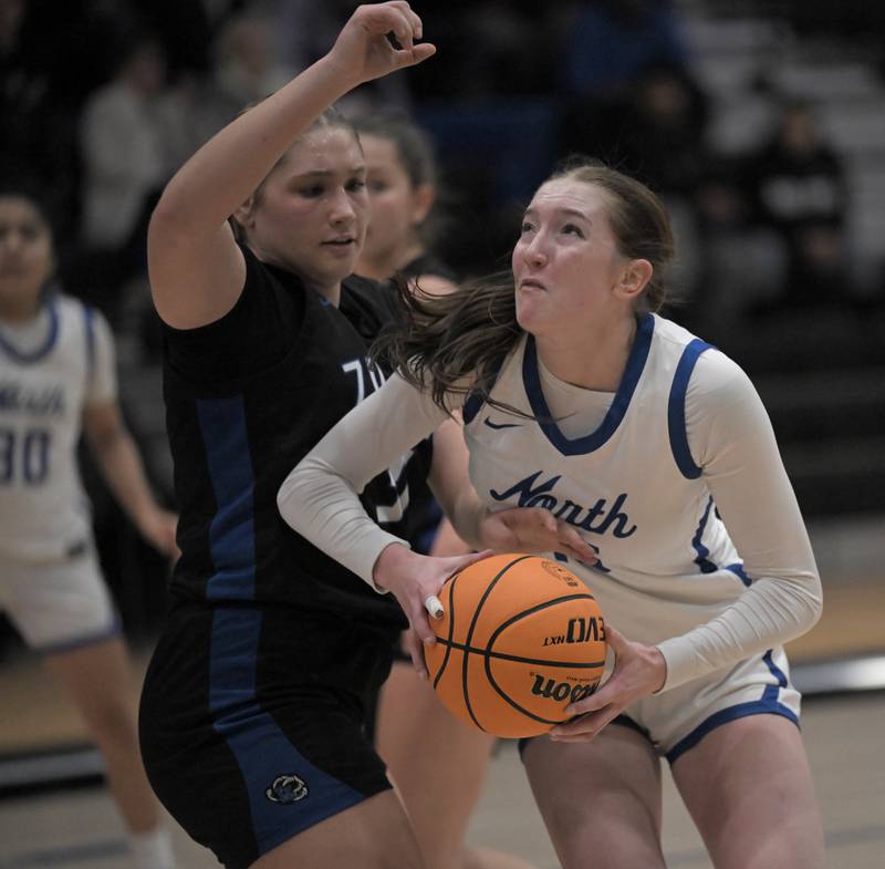 St. Charles North’s Bronwyn How tries to get past Lake Zurich’s Alex Nowak-Tice in the Exam Jamm girls basketball tournament in Lake Zurich on Tuesday, Dec. 9, 2025.