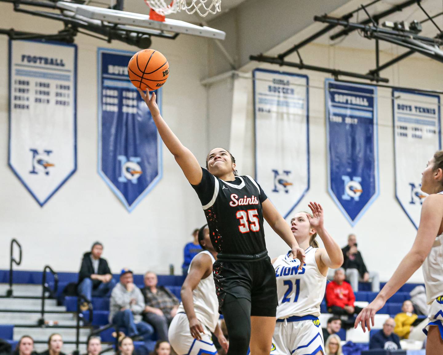 Saint Charles East's Corinne Reed (35) puts in a layup off of a drive during their Coach Kipp's Hoopfest basketball game between Lyons at St Charles East. Jan 18, 2025 in La Grange.