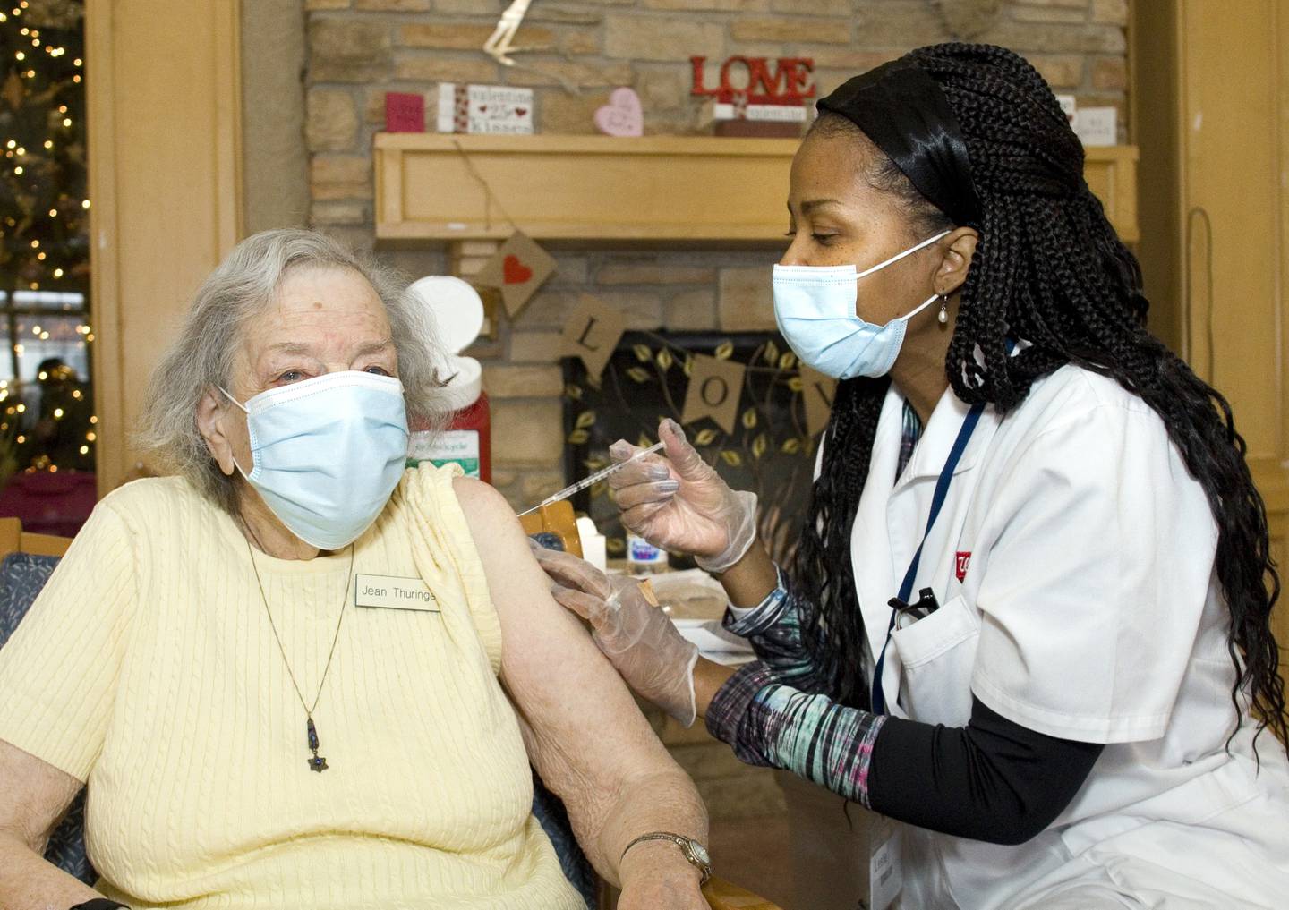 Jean Thuringer, a resident of the Timbers of Shorewood, receives the COVID-19 vaccine from Walgreens Pharmacists Leslie Jones-Hunter at Timbers of Shorewood on January 7, 2021, in Shorewood, Ill.