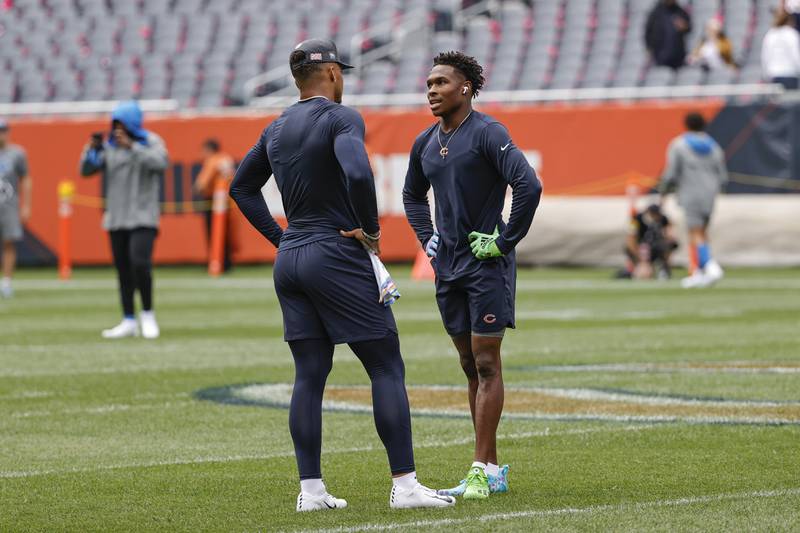 Chicago Bears quarterback Justin Fields, left, talks with wide receiver Darnell Mooney, right, prior to a game against the Detroit Lions on Oct. 3, 2021 in Chicago.