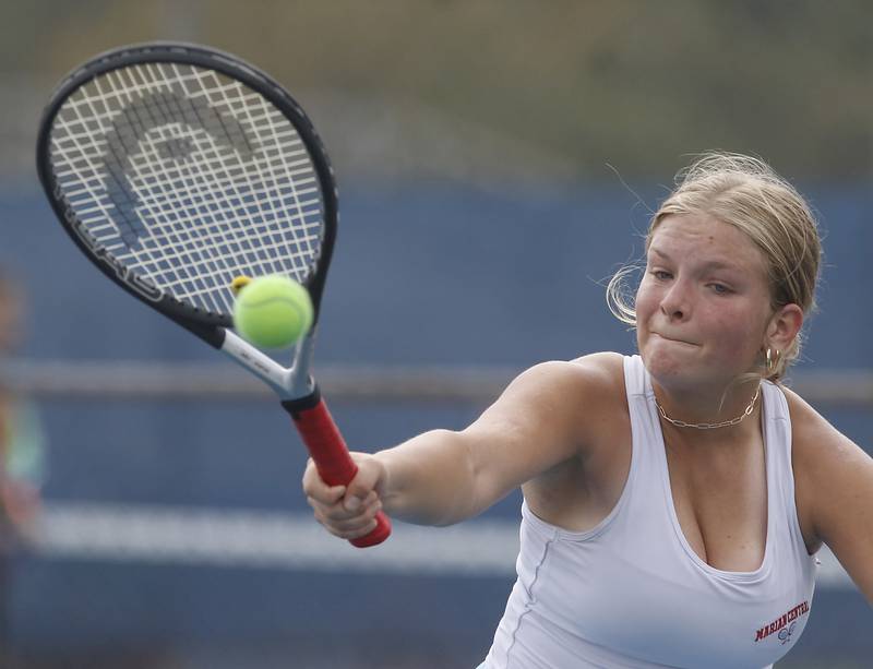 Marian Central’s Holly Garrelts volleys the ball Thursday, Oct. 19, 2023, during doubles match on the first day of the IHSA State Girls Tennis Tournament at Hoffman Estates High School in Hoffman Estates.