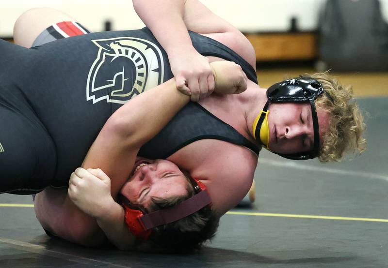 Sycamore’s Asher Dohogne pins Ottawa’s Ethan Day during their 285 pound match Thursday, Dec. 14, 2023, at Sycamore High School.