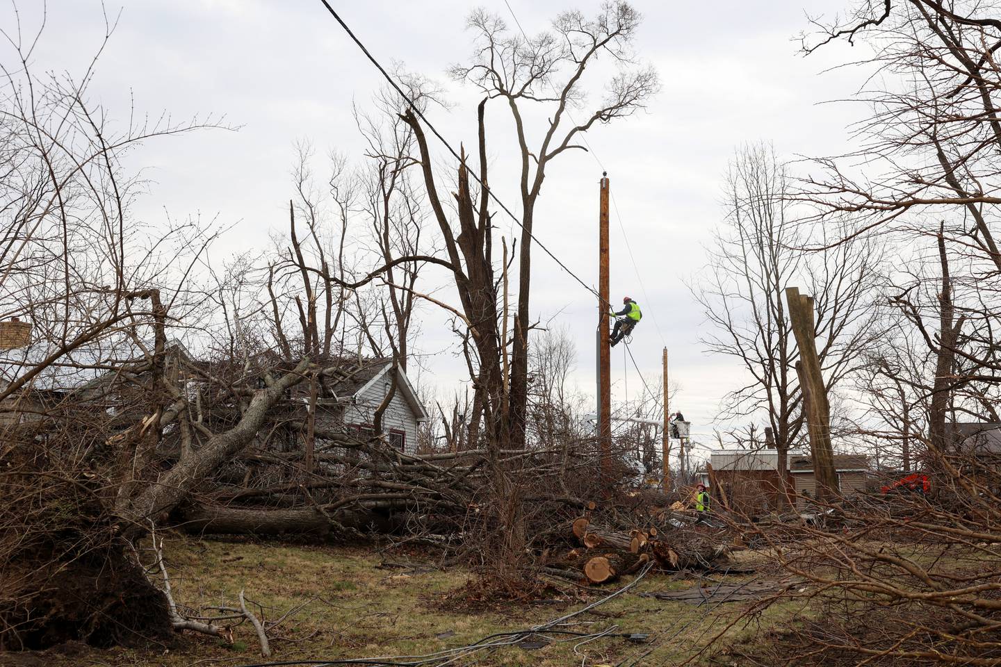 Electrical workers make progress to repairing power lines in Aroma Township on March 14, 2026, following the March 10 tornado in Kankakee County.