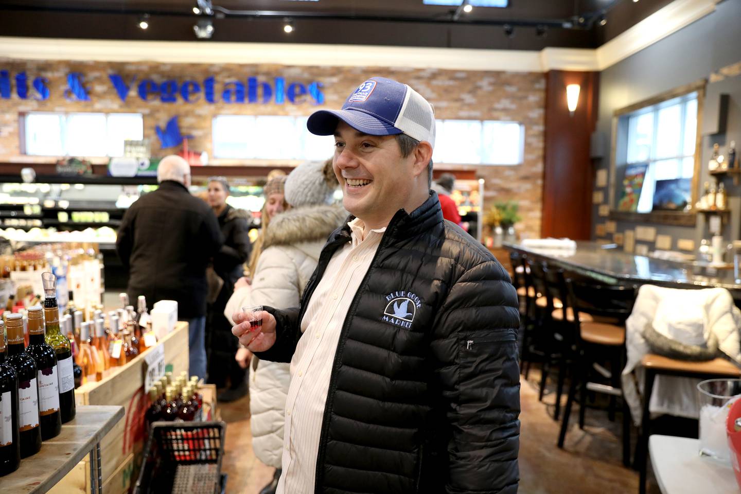 Blue Goose Market President and CEO Paul Lencioni (center) shares a toast with customers during the final wine tasting event on Thursday, Feb. 24, 2022. Lencioni announced the store was closing after more than 90 years in business in early February.