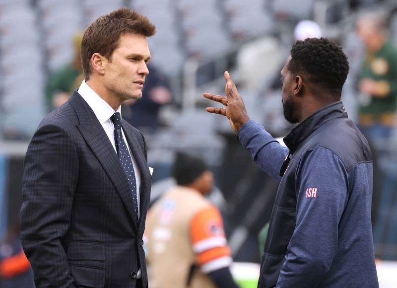 Former New England Patriot and Tampa Bay Buccaneer quarterback Tom Brady (left) talks to former Chicago Bears defensive back Charles “Peanut” Tillman before the Bears, Packers game Sunday, Nov. 17, 2024, at Soldier Field in Chicago.