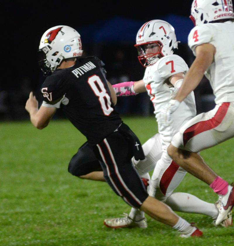 Stillman Valley quarterback Brandon Pittman (8) evades Oregon's Ethan Peeling (7) on Friday, Oct. 10, 2025 against Oregon  in Stillman Valley.