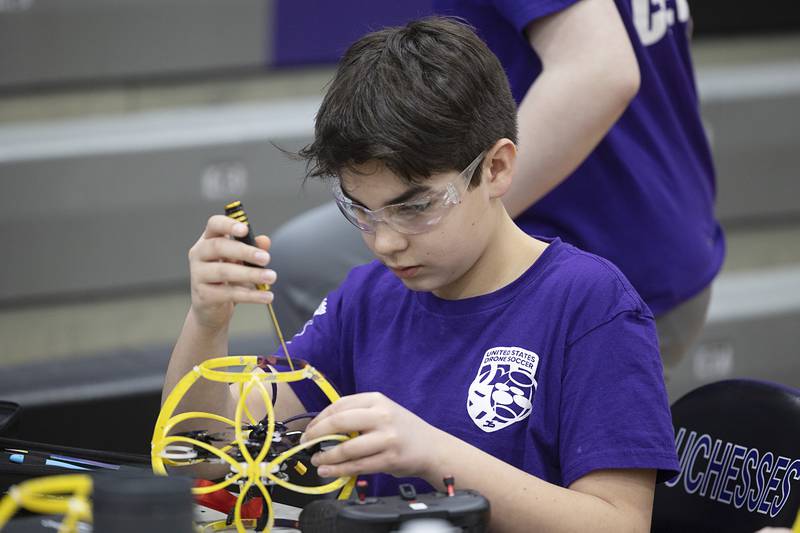 RMS drone soccer team member Carter Rhodes makes repairs to his drone Saturday, Feb. 24, 2024. Each match consists of a best of three sets with five minutes between for drone maintenance.
