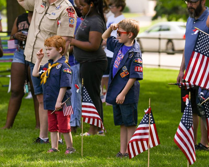 Henry Robertson, 9, and Harvey Robertson, 6, of DeKalb Salute during the Star-Spangled Banner during the Memorial Day ceremony held on the Ellwood House lawn in DeKalb on Monday May 30th.