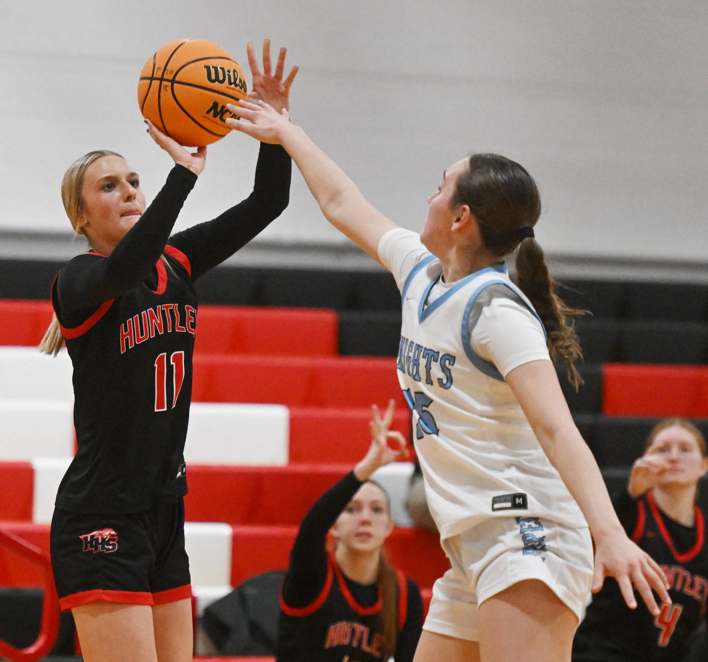 Huntley’s Anna Campanelli, left, hits a three-point shot while being closely guarded by Prospect’s Zoe Black during a game played at Forest View Educational Center on Saturday, Jan. 4, 2025 in Arlington Heights.