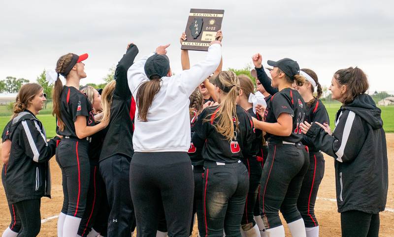 Yorkville's players raise the Class 4A Regional Championship Plaque in celebration of their victory over Plainfield North at Oswego East High School on Friday, May 27, 2022.