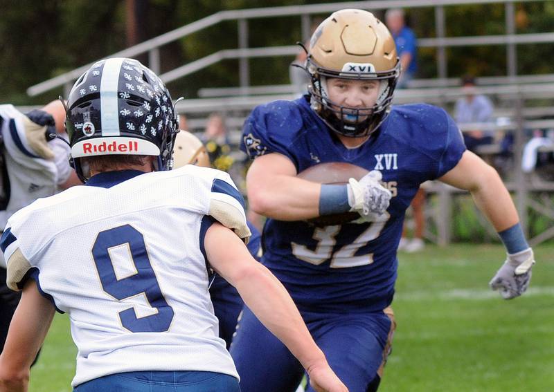 Marquette’s Grant Dose eyes Knoxville’s Austin Harshbarger on a run during the 1st quarter Saturday at Marquette.